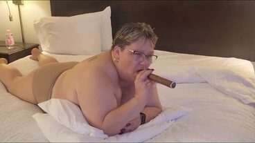 An old woman smokes a huge cigar and gets her pussy stuffed with it